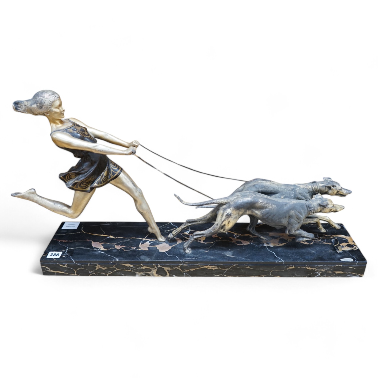 An Art Deco spelter group of a girl and two dogs, signed Geo. Maxim, 77.5cm long. Condition - poor